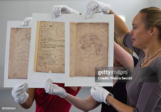 Curators handling copies of Thomas Harriot's Moon map from 1609 during a photocall at the Science Museum for the unveiling of the Cosmos & Culture,...