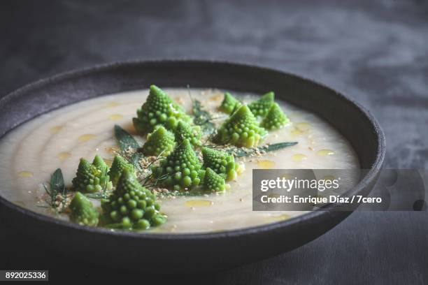 romanesco white winter soup with garnish - cauliflower bowl stock pictures, royalty-free photos & images