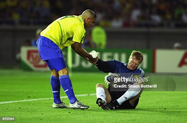 Oliver Kahn of Germany is helped up by Ronaldo of Brazil during the World Cup Final match played at the International Stadium Yokohama, Yokohama,...