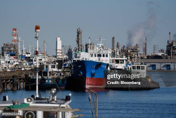 Ships sit moored in the Keihin industrial area of Kawasaki, Kanagawa Prefecture, Japan, on Tuesday, Dec. 12, 2017. The Bank of Japan will release the...