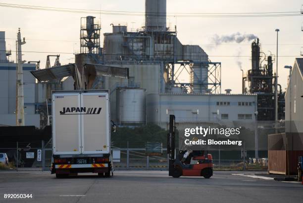 Worker operates a forklift truck in the Keihin industrial area of Kawasaki, Kanagawa Prefecture, Japan, on Tuesday, Dec. 12, 2017. The Bank of Japan...