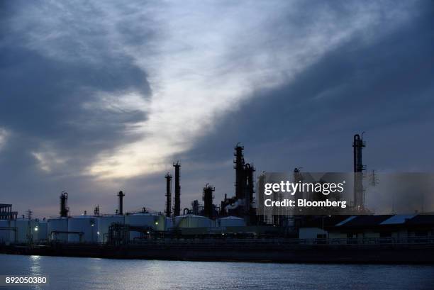 Storage tanks and stacks stand at dusk in the Keihin industrial area of Kawasaki, Kanagawa Prefecture, Japan, on Tuesday, Dec. 12, 2017. The Bank of...