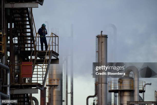 Worker stand on a flight of steps at a chemical plant in the Keihin industrial area of Kawasaki, Kanagawa Prefecture, Japan, on Tuesday, Dec. 12,...