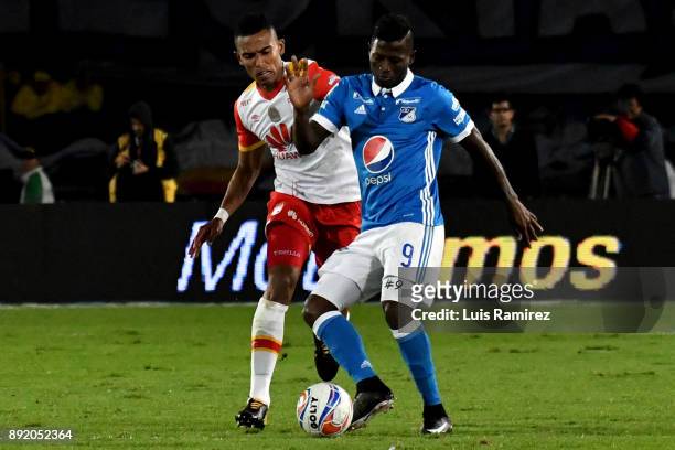 Duvier Riascos of Millonarios vies for the ball with William Tesillo of Independiente Santa Fe, during the first leg match between Millonarios and...
