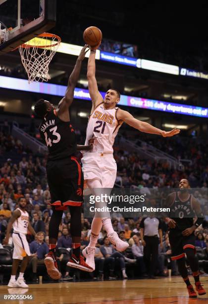 Alex Len of the Phoenix Suns attempts a slam dunk over Pascal Siakam of the Toronto Raptors during the second half of the NBA game at Talking Stick...