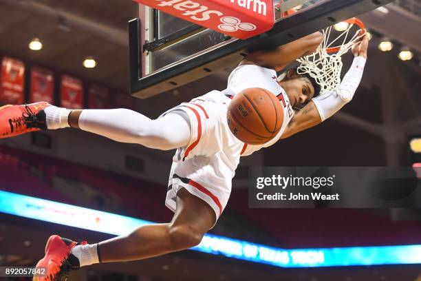 Justin Gray of the Texas Tech Red Raiders hangs on the rim after dunking the basketball during the game against the Kennesaw State Owls on December...