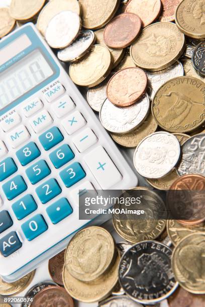 a calculator is on a pile of coins - the 2017 budget preparation stock pictures, royalty-free photos & images