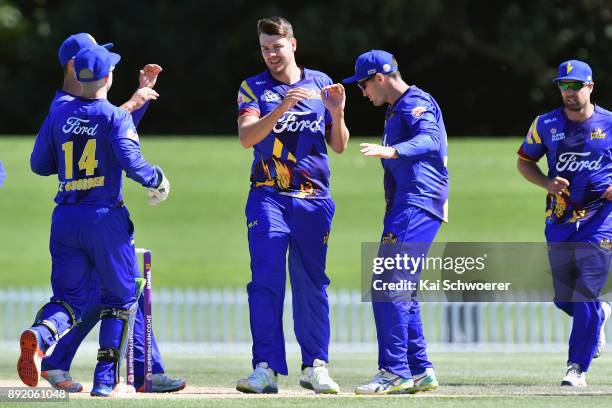 Jacob Duffy of Otago is congratulated by team mates after dismissing Chad Bowes of Canterbury during the Supersmash Twenty20 match between Canterbury...