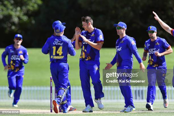 Jacob Duffy of Otago is congratulated by team mates after dismissing Chad Bowes of Canterbury during the Supersmash Twenty20 match between Canterbury...