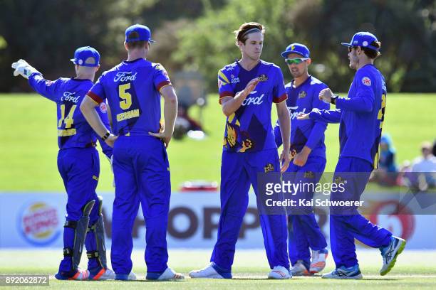 Warren Barnes of Otago is congratulated by team mates after dismissing Andrew Ellis of Canterbury during the Supersmash Twenty20 match between...