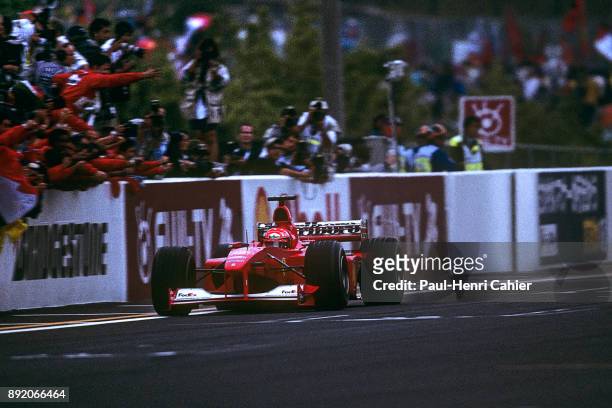 Michael Schumacher, Ferrari F1-2000, Grand Prix of Japan, Suzuka Circuit, 08 October 2000. Michael Schumacher crosses the finish line of the 2000...