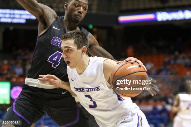 Guard Justinian Jessup of the Boise State Broncos dribbles past the defense of forward Oscar Frayer of the Grand Canyon Lopes during second half...