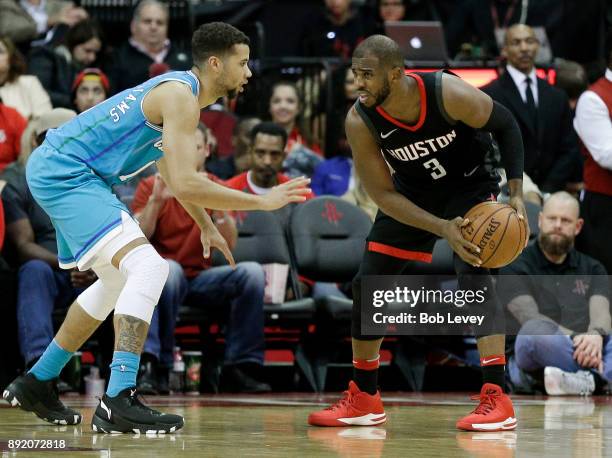 Chris Paul of the Houston Rockets looks to drive on Michael Carter-Williams of the Charlotte Hornets in the fourth qaurter at Toyota Center on...