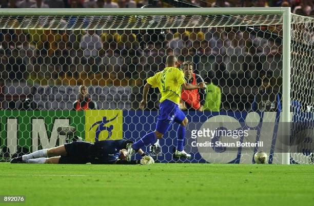 Ronaldo of Brazil scores his first goal past goalkeeper Oliver Kahn of Germany during the World Cup Final match played at the International Stadium...