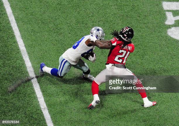 Dez Bryant of the Dallas Cowboys runs with a catch against Desmond Trufant of the Atlanta Falcons at Mercedes-Benz Stadium on November 12, 2017 in...