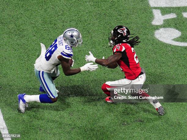 Dez Bryant of the Dallas Cowboys runs with a catch against Desmond Trufant of the Atlanta Falcons at Mercedes-Benz Stadium on November 12, 2017 in...