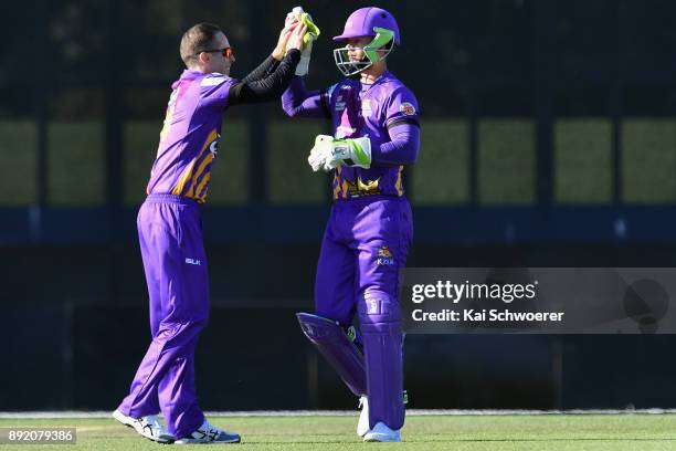 Cameron Fletcher of Canterbury is congratulated by Todd Astle of Canterbury after taking a catch to dismiss Josh Finnie of Otago during the...