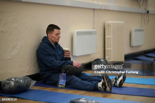 Homeless man Lee sits on a sleeping mat the new Labre House rough sleepers shelter on December 12, 2017 in Liverpool, England. Labre House, named...