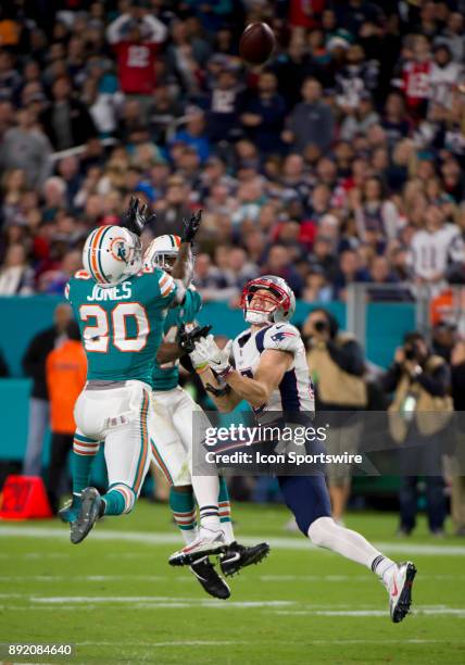 Miami Dolphins Cornerback Alterraun Verner and Miami Dolphins Safety Reshad Jones break up a pass intended for New England Patriots Wide Receiver...