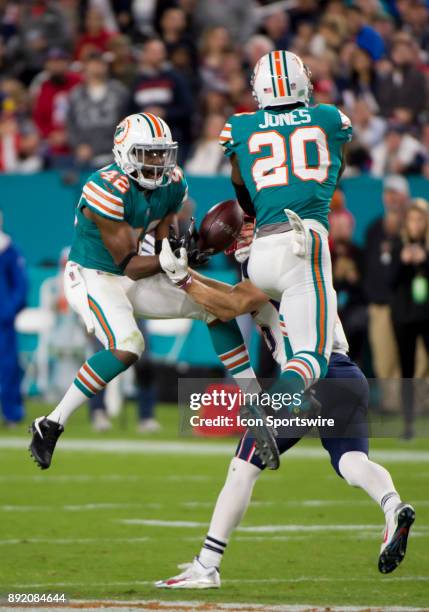 Miami Dolphins Cornerback Alterraun Verner and Miami Dolphins Safety Reshad Jones break up a pass intended for New England Patriots Wide Receiver...