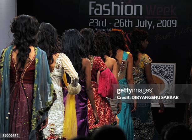Indian models walk the runway wearing designs by Parvesh and Jai during the first day of Bangalore Fashion Week 09 in Bangalore on July 23, 2009. The...