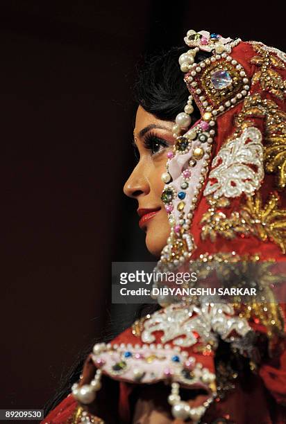 An Indian model walks the runway wearing a desing by Parvesh and Jai during the first day of Bangalore Fashion Week 09 in Bangalore on July 23, 2009....