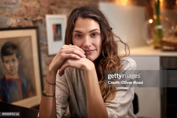 portrait of brunette woman at home - armband stock-fotos und bilder