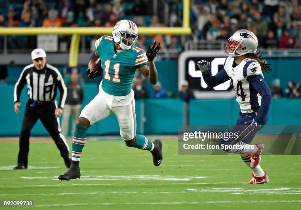 Miami Dolphins wide receiver DeVante Parker is pursued by New England defensive back Stephon Gilmore during an NFL football game between the New...