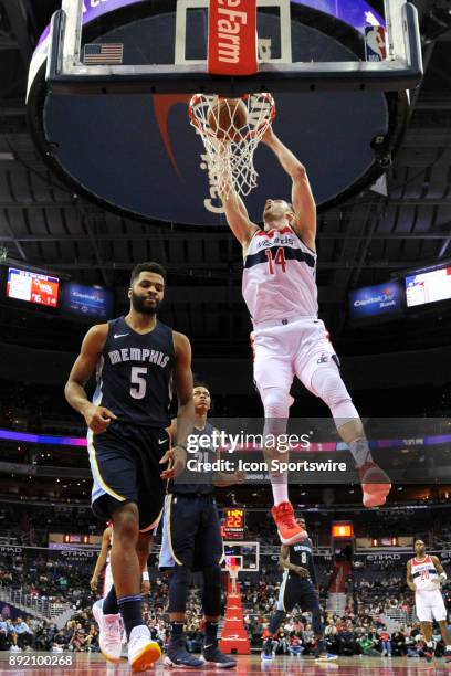 Washington Wizards forward Jason Smith scores on a first half dunk against Memphis Grizzlies guard Andrew Harrison on December 13, 2017 at the...