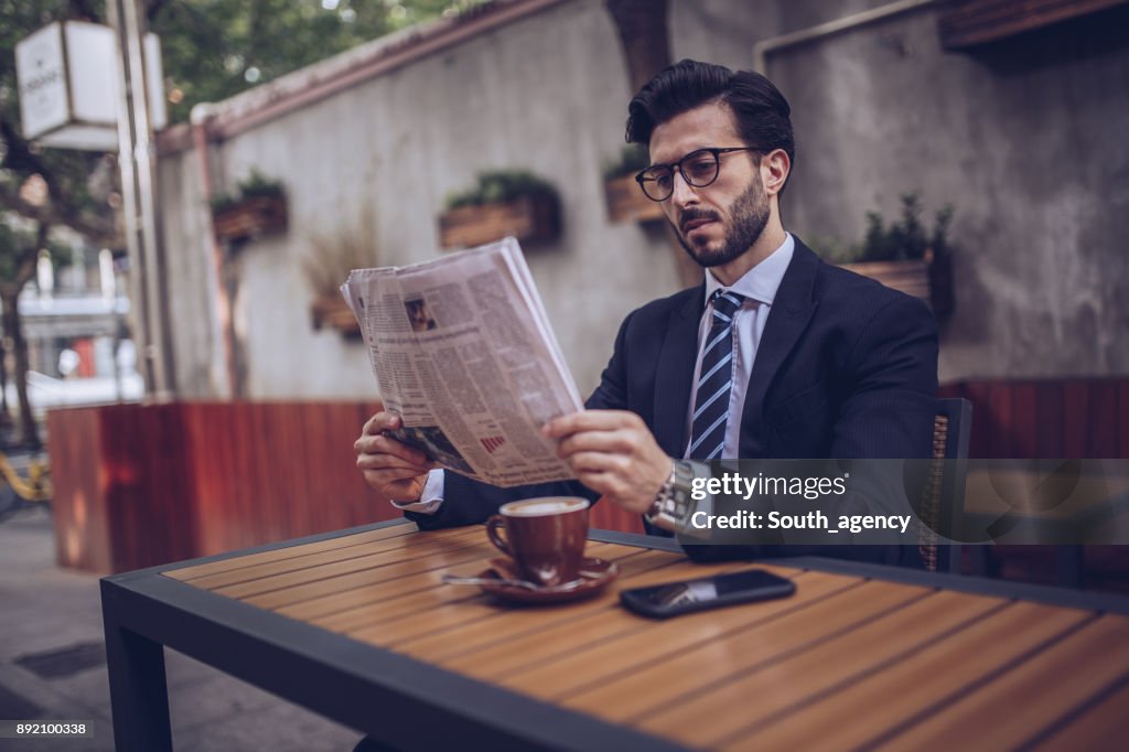 Reading the news in cafe