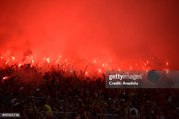 Fans of Flamengo light torches and shout slogans as they support their team ahead of the 2017 Sudamericana Cup championship final match between...