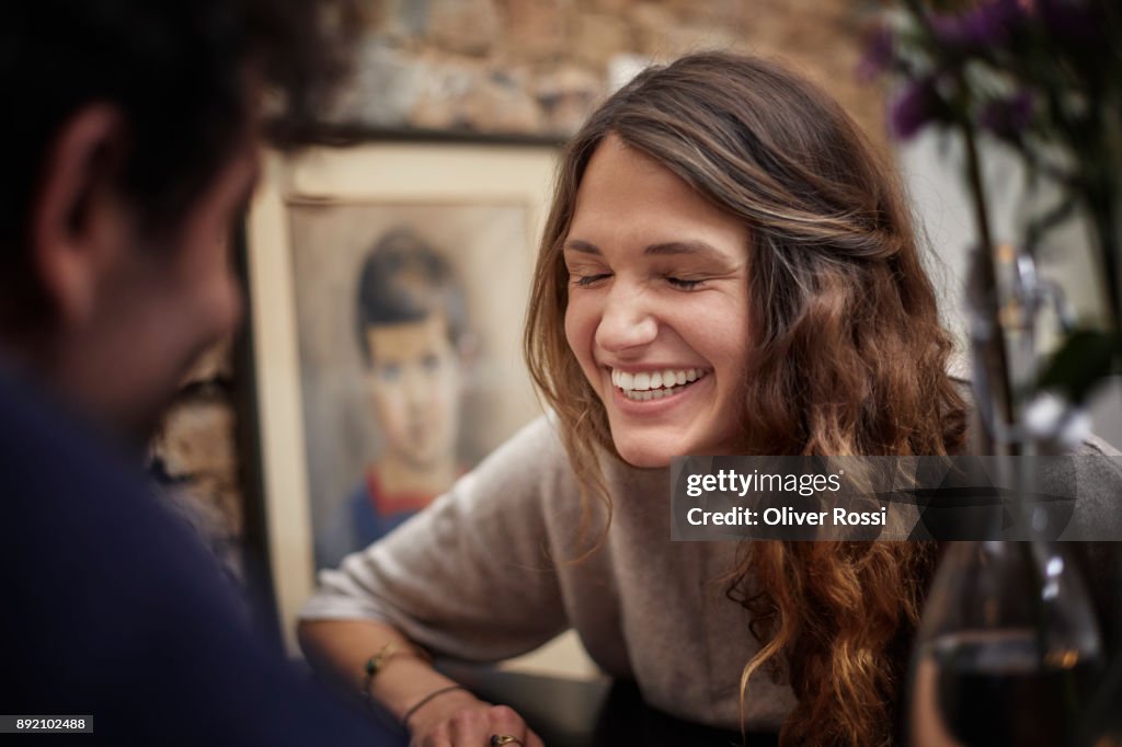 Happy young woman with man in foreground