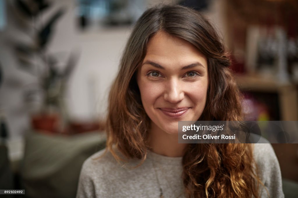 Portrait of smiling brunette woman at home