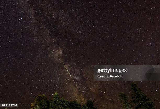 Meteor streaks across the night sky during the Geminid meteor shower over Murat Mountains in Gediz district of Kutahya, Turkey on December 14, 2017....