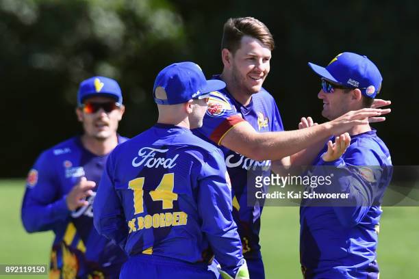 Jacob Duffy of Otago is congratulated by team mates after dismissing Michael Pollard of Canterbury during the Supersmash Twenty20 match between...