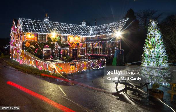 Lights illuminate the Queen Victoria Inn in the village of Priddy that has been transformed into a giant gingerbread house in time for Christmas,...