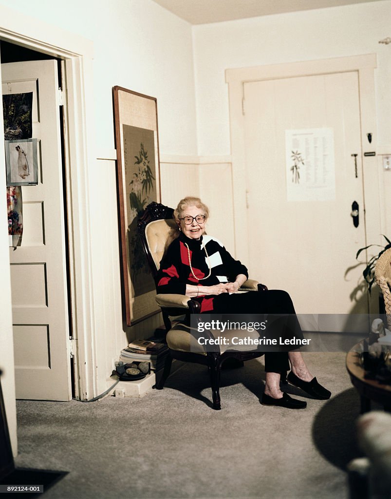 Elderly woman sitting in chair