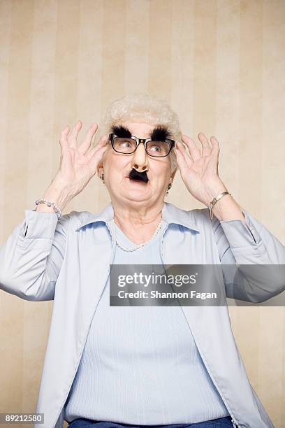 elderly woman wearing silly disguise - groucho marx disguise stock pictures, royalty-free photos & images