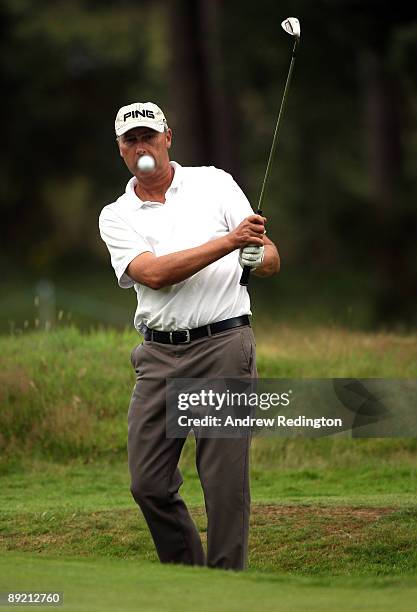 Mike Harwood of Australia plays a chip shot on the 16th hole during the first round of The Senior Open Championship presented by MasterCard held on...