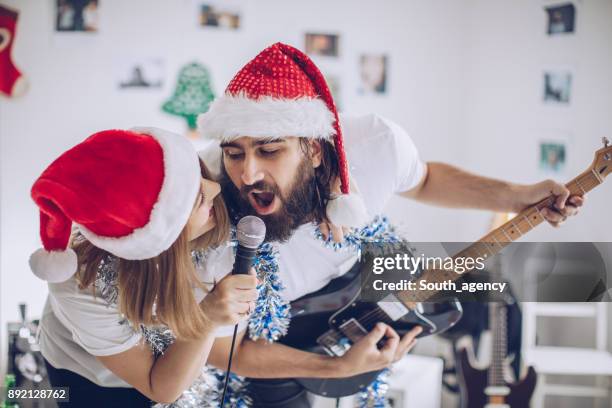 christmas celebration together - christmas singing stock pictures, royalty-free photos & images