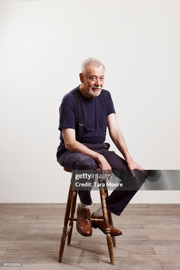 Portrait of old man sitting on chair