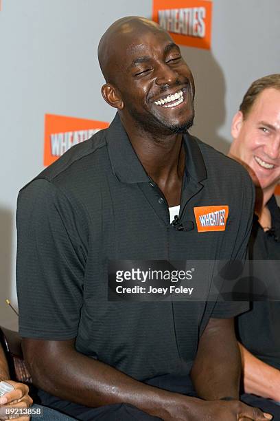 Basketball star Kevin Garnett and Indianapolis Colts quarterback Peyton Manning share a laugh during a press conference at Conseco Fieldhouse on July...