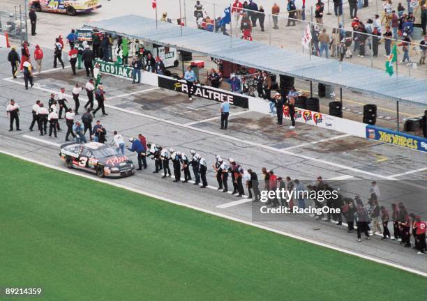 Dale Earnhardt Sr. Driver of the GM Goodwrench Chevrolet celebrates with every crew member of every team on pit road after winning the 1998 NASCAR...