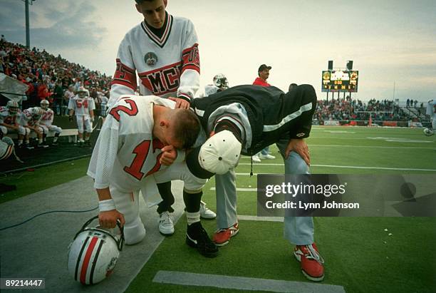 McKinley High QB Josh McDaniels with coach, his father Thom McDaniels on sidelines after losing game with overtime point after tochdown by Massillon...