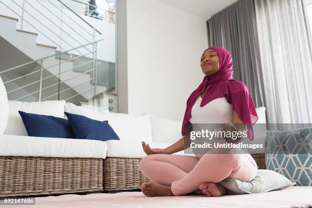 pregnant woman practicing yoga - pregnant muslim stock pictures, royalty-free photos & images