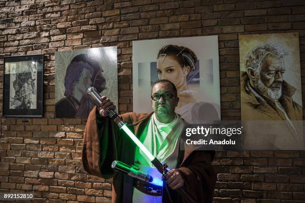 Fan poses for a photo with lightsabers during a gathering for the latest of the Star Wars film series "Star Wars: The Last Jedi" movie in Istanbul,...