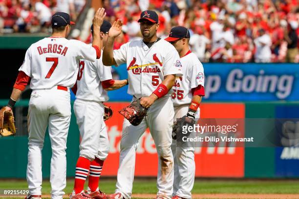 Albert Pujols of the St. Louis Cardinals congratulates teammates after beating the Arizona Diamondbacks on July 19, 2009 at Busch Stadium in St....