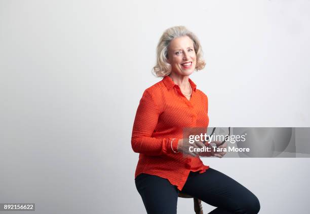 professional older woman sitting on chair - transparent blouse stock pictures, royalty-free photos & images