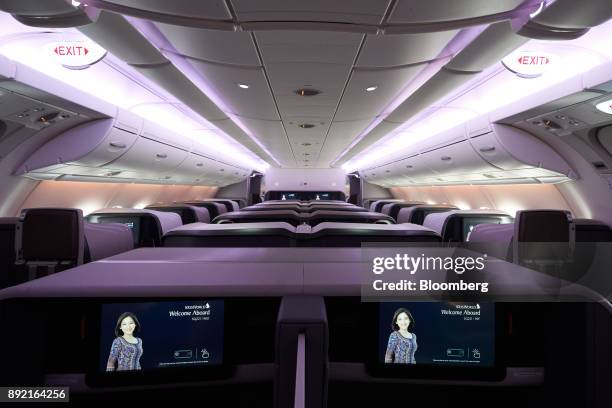 Business class seats of a Singapore Airlines Ltd. Airbus SE A380 aircraft with refitted cabins are seen during a media tour at Changi Airport in...