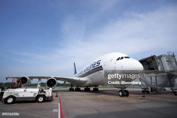Singapore Airlines Ltd. Airbus SE A380 aircraft with refitted cabins arrives at Changi Airport in Singapore, on Thursday, Dec. 14, 2017. In the...